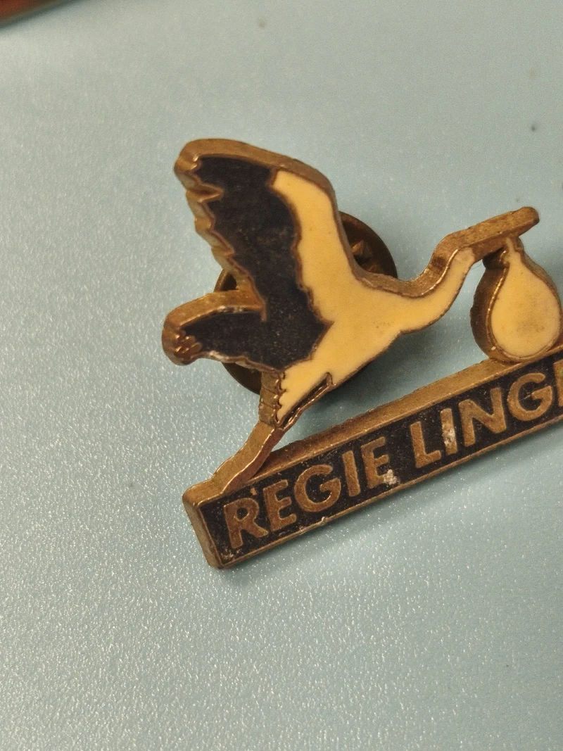 Vintage pin's cigogne REGIE LINGE ancien badge publicitaire collection