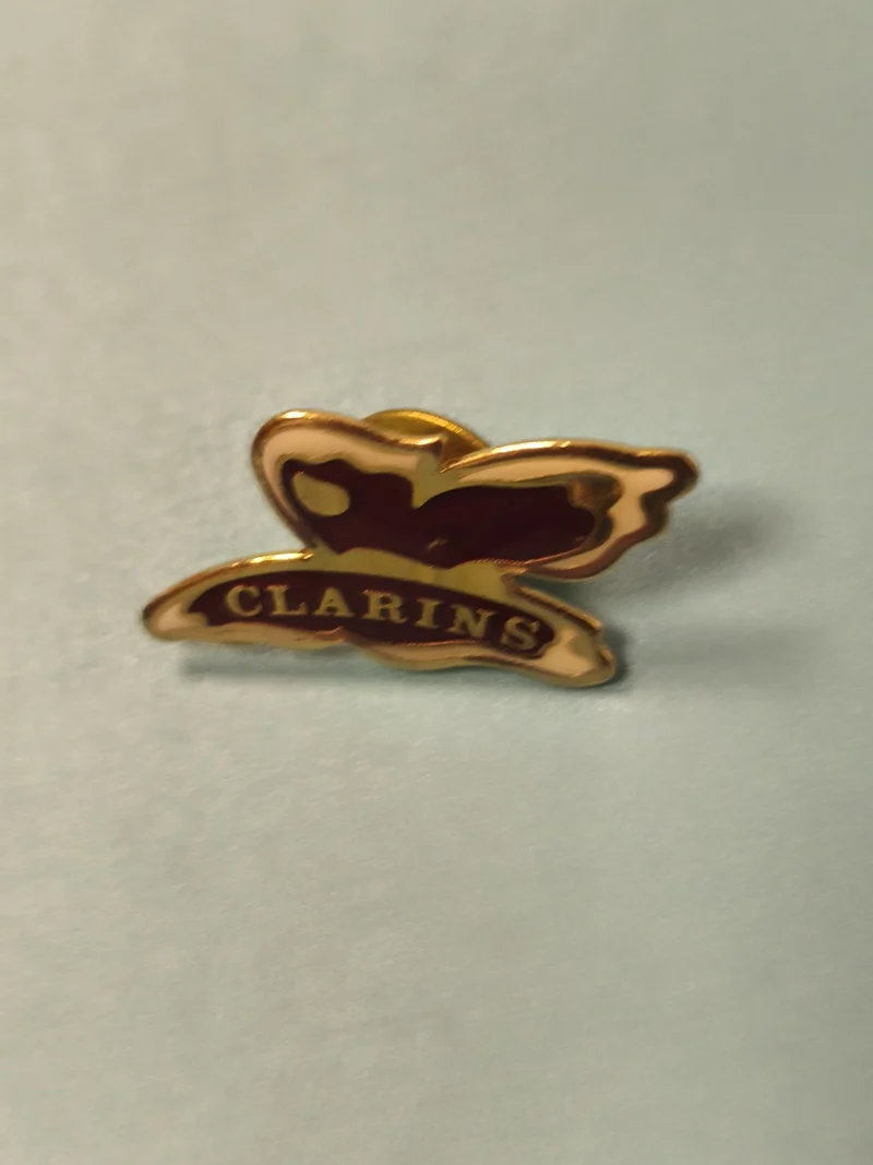 Pin's vintage Clarins papillon doré émaillé ancien collection publicitaire