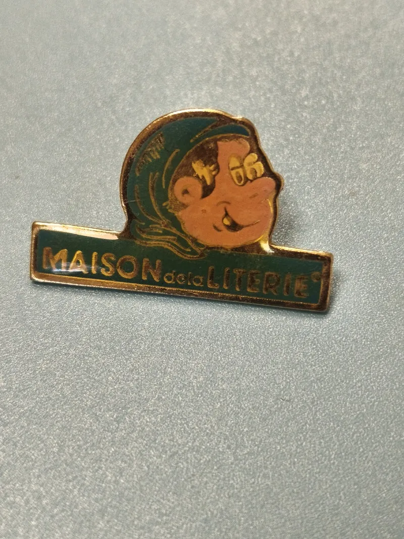 Pin's vintage Maison de la Literie mascotte bonnet bleu collection publicitaire