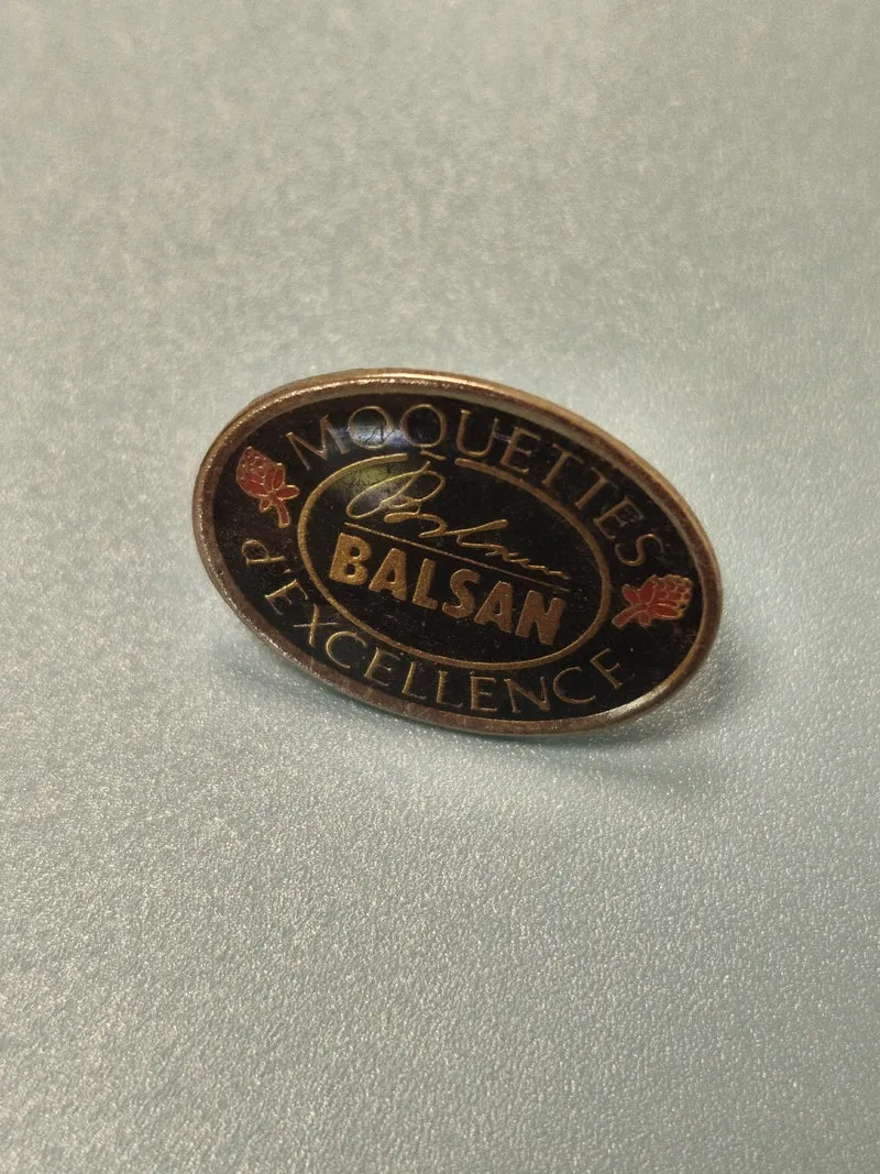 Vintage pin's publicitaire Moquettes Balsan ovale noir doré collection