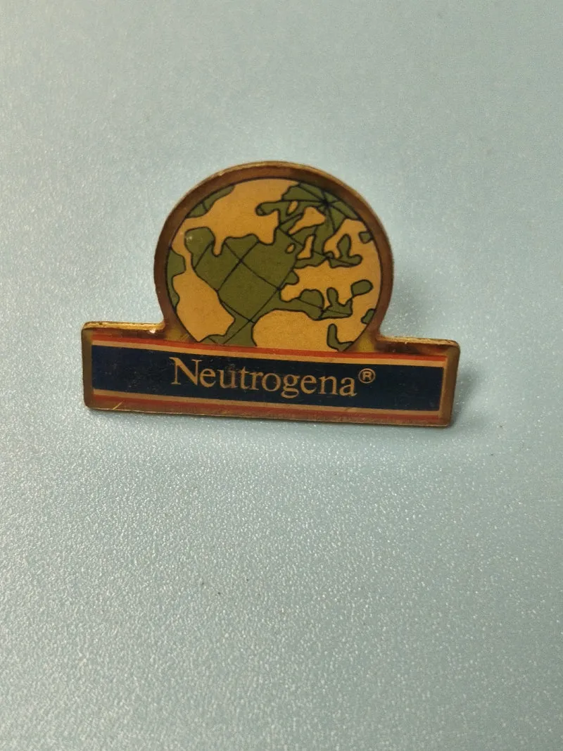 Vintage pin's Neutrogena globe ancien badge publicitaire collection