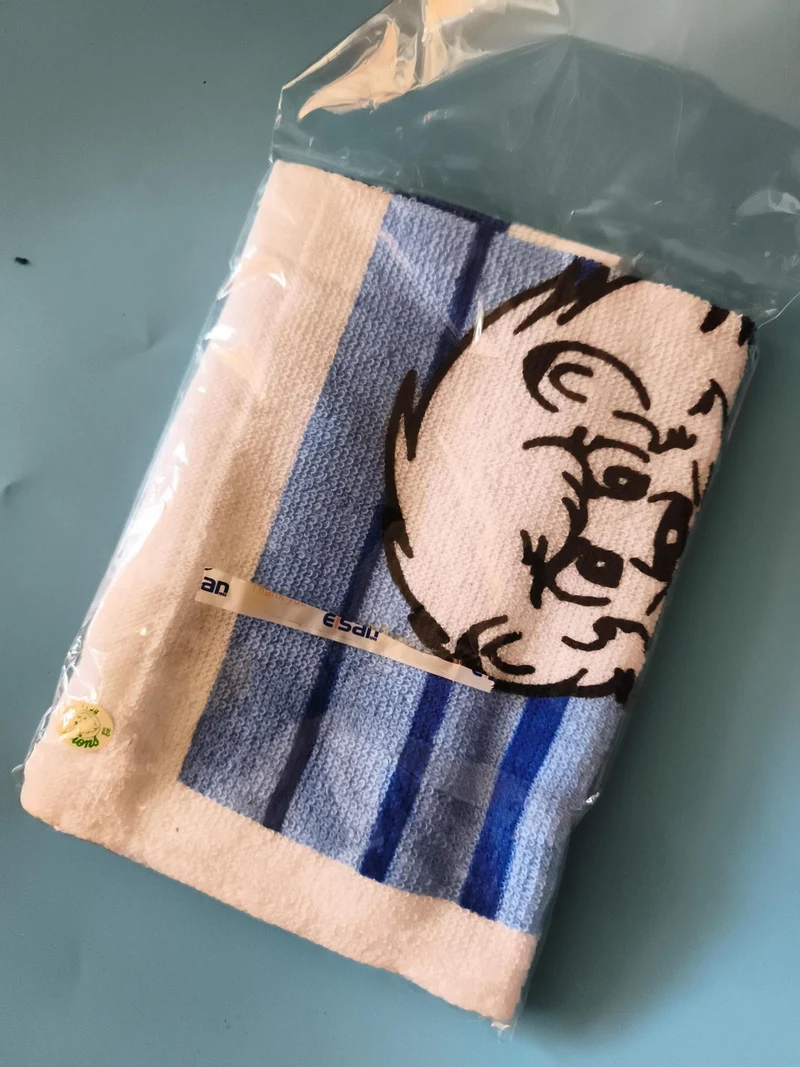 Serviette vintage Le Roi Léo rayée bleu blanc, motif lion, neuve emballée