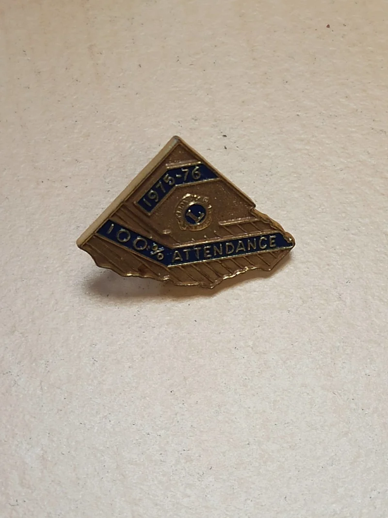 Pin's ancien Lions Club 1975-76, insigne vintage 100% attendance doré rétro